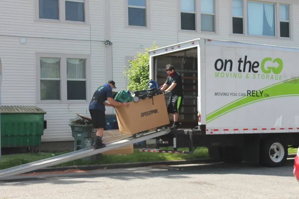 On The Go Moving crew loading furniture onto a moving truck