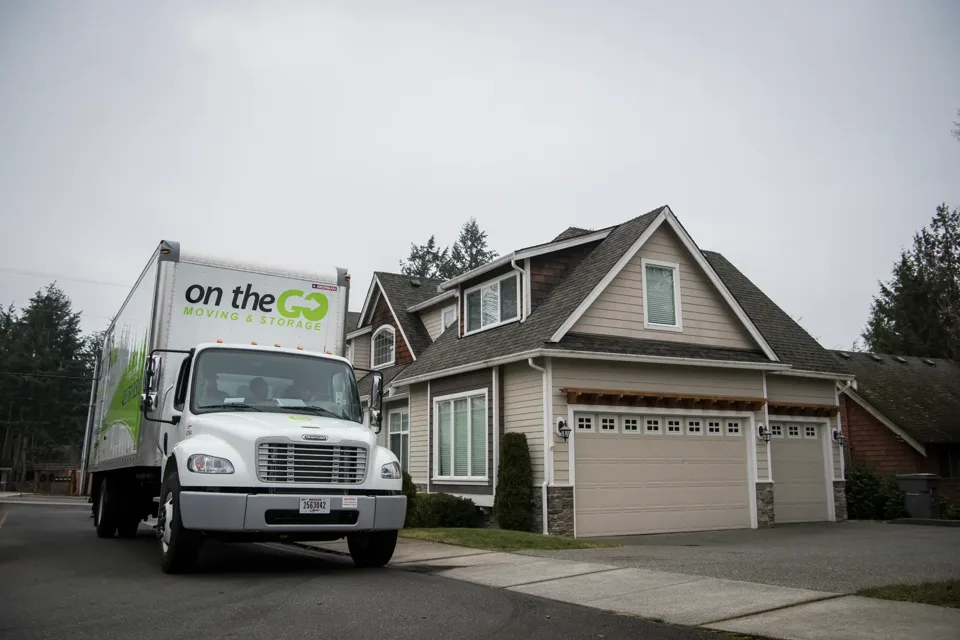 On The Go Moving truck parked outside a residential home