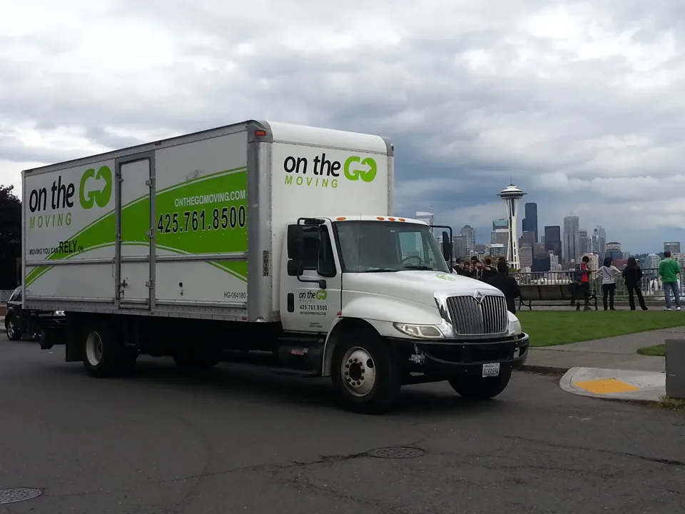 On The Go Moving truck with the Seattle skyline in the background