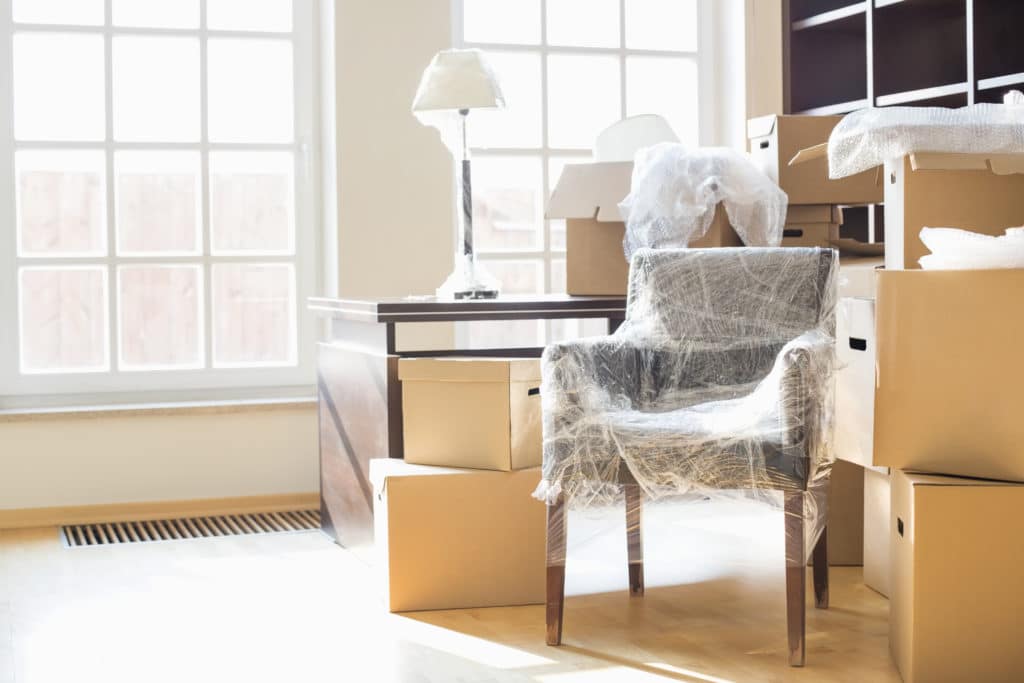 white colored lamp on top of table with piled boxes